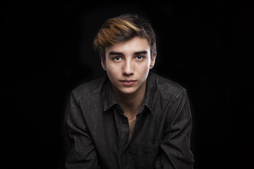 Fototapeta premium portrait of a young handsome man on black background