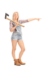 Woman in overalls holding an axe