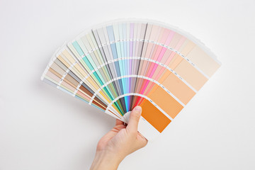 Hand holding multicolored cardboards