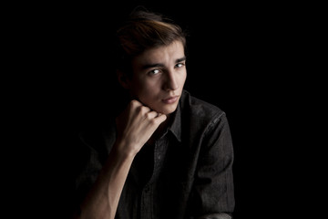 portrait of a young handsome man on black background