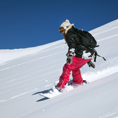 Fototapeta na wymiar Snowboarder moving down
