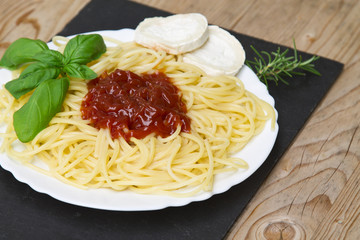 spaghetti dish with goat cheese and tomato