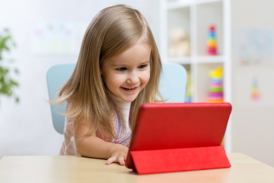 happy child little girl using tablet computer