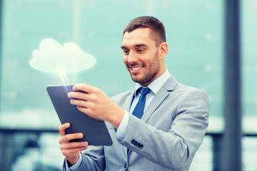 smiling businessman with tablet pc outdoors