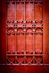 Red door detail with wrought iron ornaments