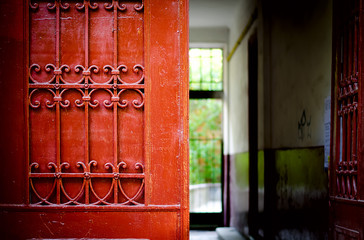 Red door detail with wrought iron ornaments