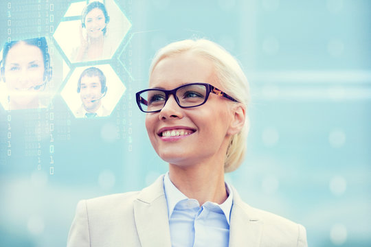 young smiling businesswoman in eyeglasses outdoors