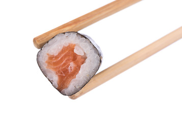 Sushi roll held by chopsticks