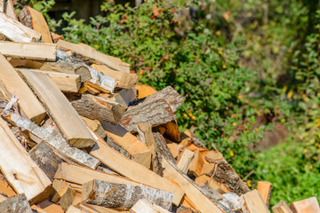 Old axe in log on a firewood background. Shallow depth of field,