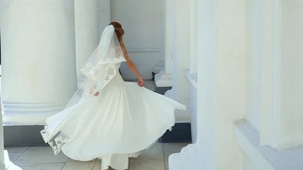 Beautiful young bride in white wedding dress turning around. Happy bride celebrating her marriage. Slow motion video footage. - Powered by Adobe