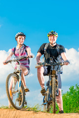 Vertical shot of a smiling couple on a bicycle