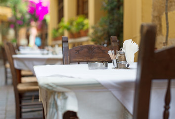Mediterranean restaurant terrace exterior with chairs.