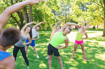 group of friends or sportsmen exercising outdoors