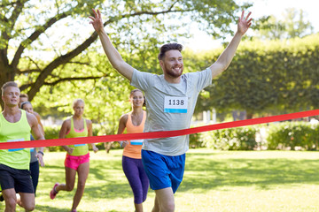 happy young male runner winning on race finish