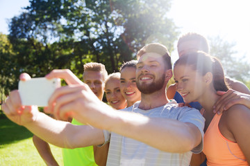 happy friends taking selfie with smartphone