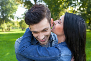 girl whispers her boyfriend a secret