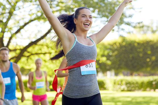 Happy Young Female Runner Winning On Race Finish