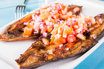 fried bangus or milkfish topped with fresh sliced onions and tomatoes