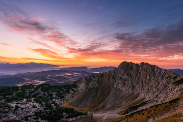 Sunrise in the mountains. Early morning as viewed from the top of Visevnik hill with vast landscape below.