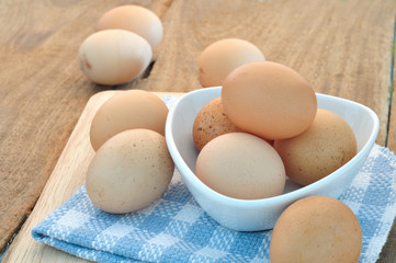 Group of Eggs on the plate and wooden floors.