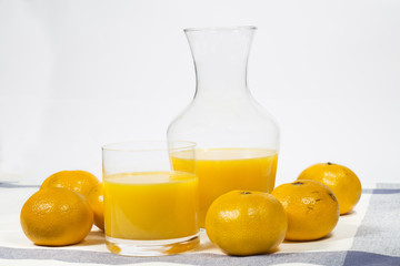 Natural tangerine orange juice on white