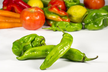 Green peppers in front of a bunch of vegetables