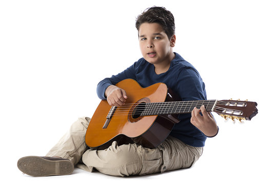 Child guitarist playing classical guitar and singing isolated 