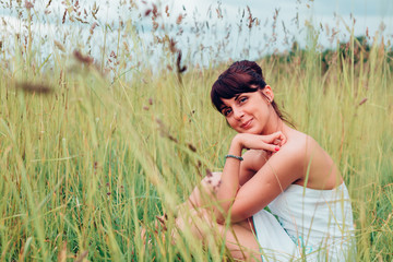 beautiful Russian girl sits in a meadow © PT88