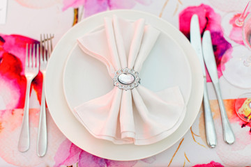 Beautifully served table in a restaurant / Luxury table service on the flower background in an event, celebration or wedding