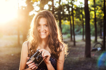 young caucasian female with vintage camera in park