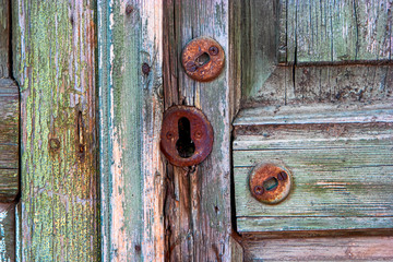 Old wooden door and rusty keyhole in Astrakhan, Russia