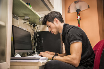 Young Man with Doing Homework at Computer Desk