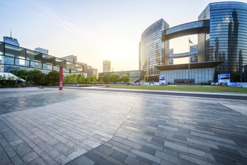 modern square and skyscrapers under sunbeam