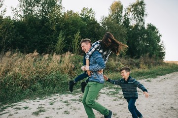 vacation young family near the lake, happy father, mother and so