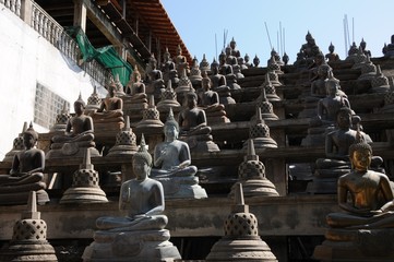 Set of Buddha statues and small stupas in Gangaramaya temple,