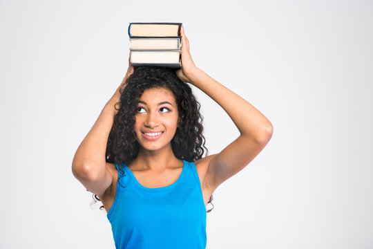 Happy afro american woman holding books on the head