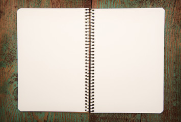blank notebook on wooden table.