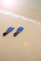 Blue diving fins on  the beach