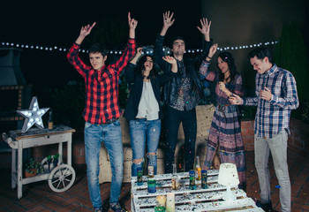 Happy friends dancing and having fun in a party