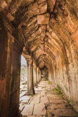Fototapeta na wymiar Corridor with sculpture on the wall in Angkor Thom