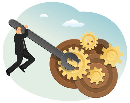 Businessman is trying to fix a mechanism of gears. He's hanging on the big wrench.