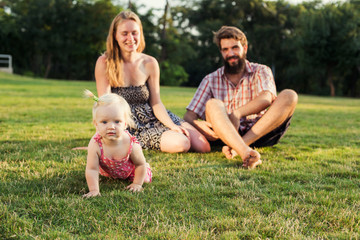 young happy family having fun outdoors in park