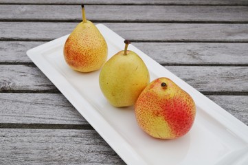 Three small Forelle pears in a row