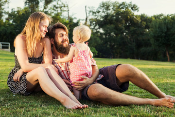 Fototapeta premium young happy family having fun outdoors in park
