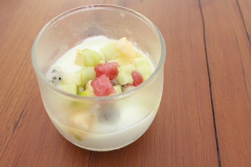 Soy custard in fresh milk in glass on wooden table