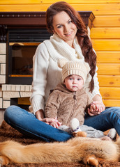 Obraz premium Mother and baby playing and smiling. Happy family.Home interior.