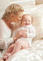 Mother and baby playing and smiling. Happy family.Home interior.