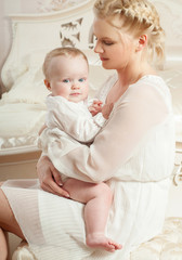 Mother and baby playing and smiling. Happy family.Home interior.
