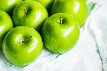 Bright green apples on white napkin