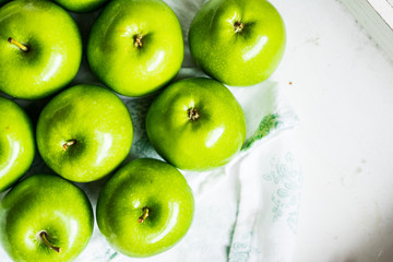 Bright green apples on white napkin
